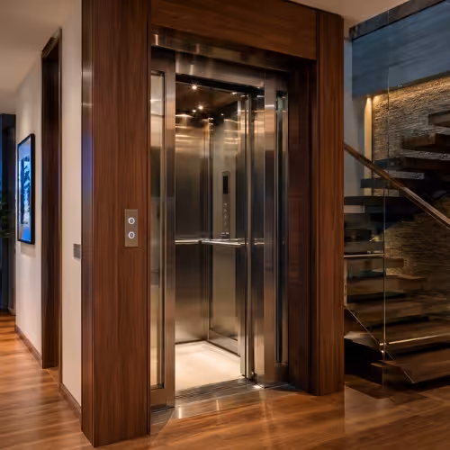 Modern residential elevator inside a luxury villa with wood and stainless steel finishing by TheNova Elevators